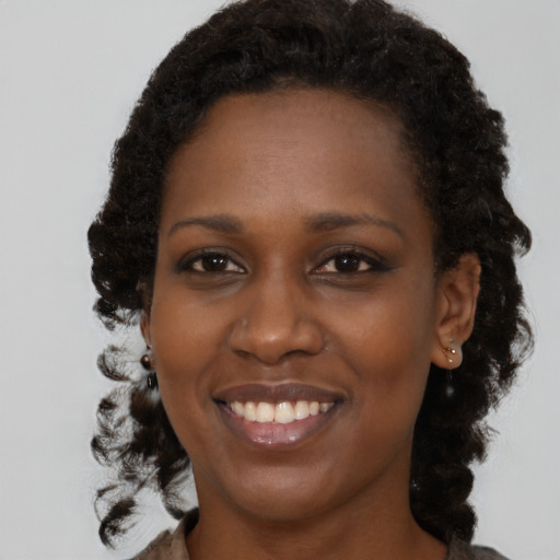 Joyful black young-adult female with medium  brown hair and brown eyes