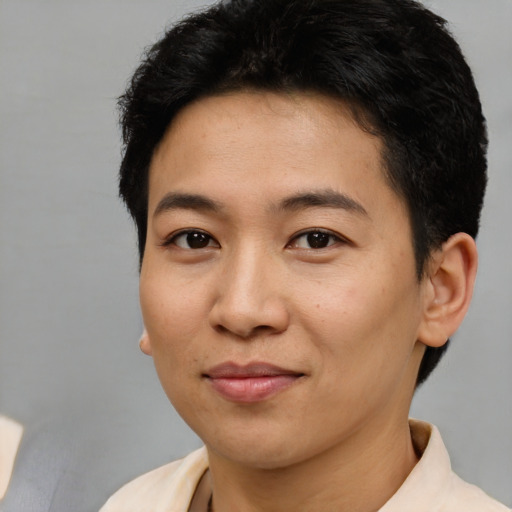 Joyful asian young-adult female with short  brown hair and brown eyes