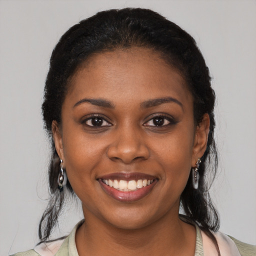 Joyful black young-adult female with medium  black hair and brown eyes