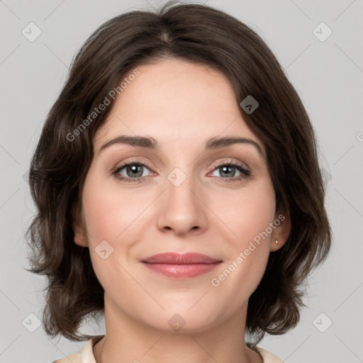 Joyful white young-adult female with medium  brown hair and green eyes