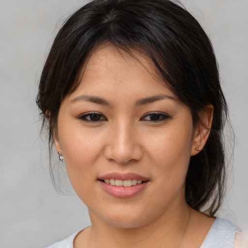 Joyful asian young-adult female with medium  brown hair and brown eyes