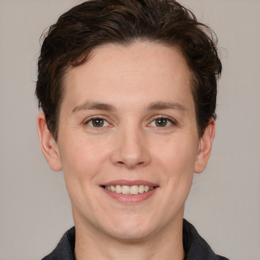 Joyful white young-adult female with short  brown hair and grey eyes