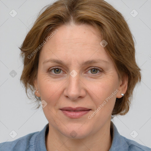 Joyful white adult female with medium  brown hair and blue eyes