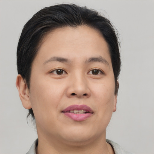 Joyful asian young-adult female with short  brown hair and brown eyes