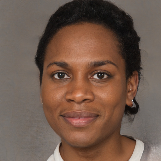 Joyful black young-adult female with short  brown hair and brown eyes