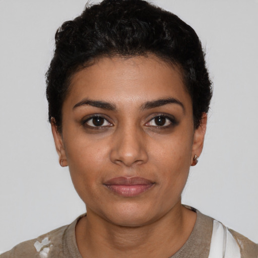 Joyful latino young-adult female with short  black hair and brown eyes