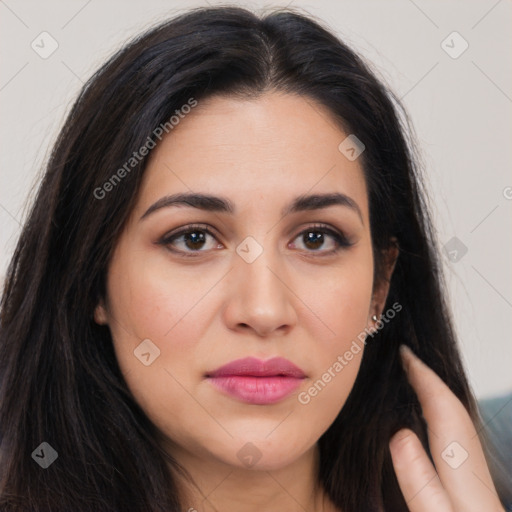 Joyful latino young-adult female with long  brown hair and brown eyes