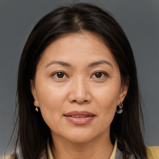Joyful white adult female with long  brown hair and brown eyes