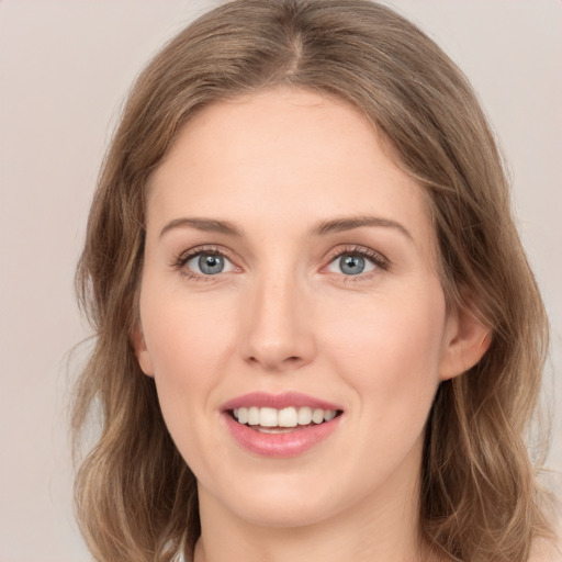 Joyful white young-adult female with medium  brown hair and green eyes