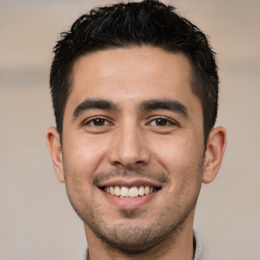 Joyful white young-adult male with short  black hair and brown eyes