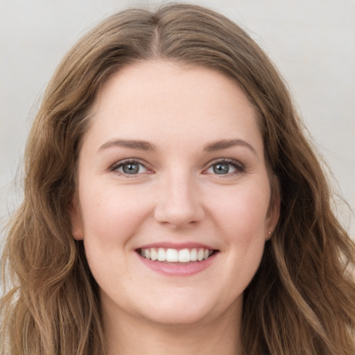 Joyful white young-adult female with long  brown hair and grey eyes