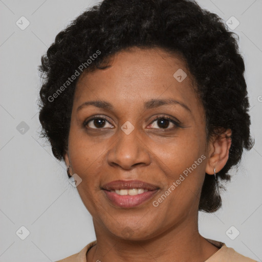 Joyful black adult female with short  brown hair and brown eyes