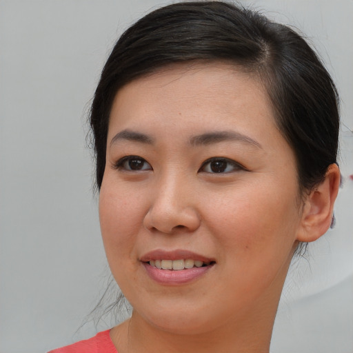 Joyful asian young-adult female with medium  brown hair and brown eyes