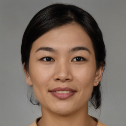 Joyful asian young-adult female with medium  black hair and brown eyes