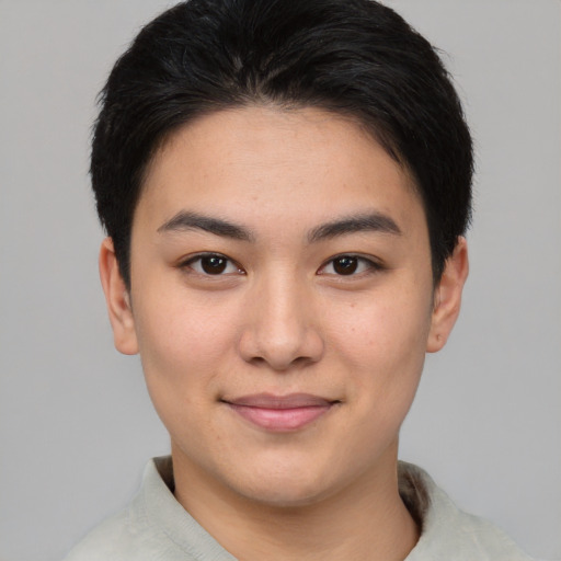Joyful asian young-adult female with short  brown hair and brown eyes