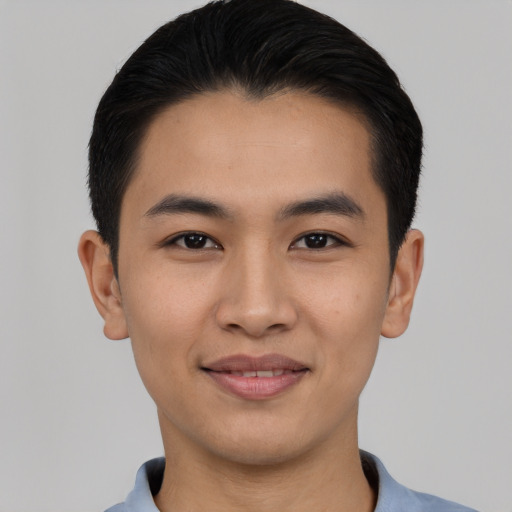 Joyful asian young-adult male with short  black hair and brown eyes