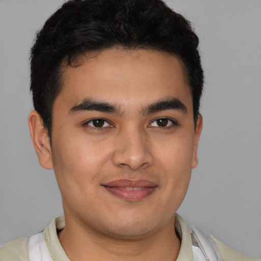 Joyful latino young-adult male with short  brown hair and brown eyes