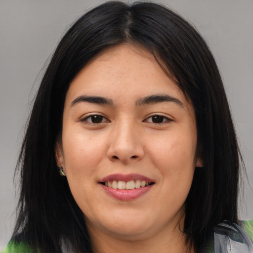 Joyful asian young-adult female with long  brown hair and brown eyes