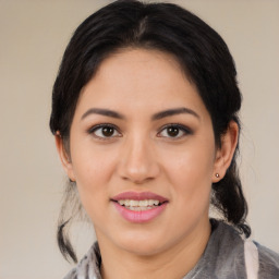 Joyful latino young-adult female with medium  brown hair and brown eyes