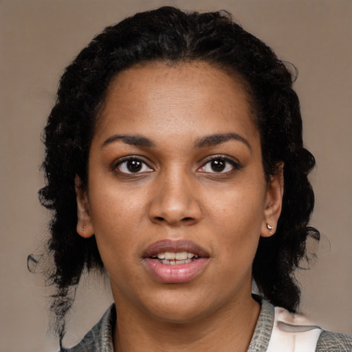 Joyful black young-adult female with medium  black hair and brown eyes