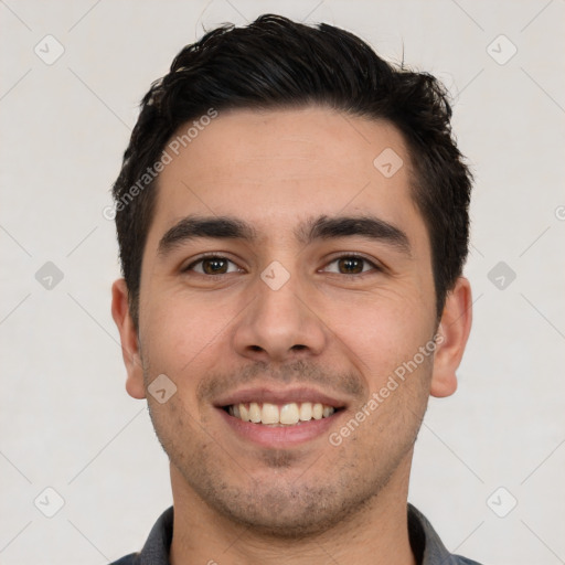 Joyful white young-adult male with short  black hair and brown eyes