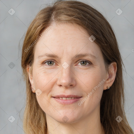 Joyful white adult female with long  brown hair and grey eyes