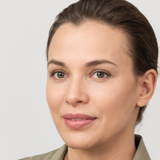 Joyful white young-adult female with medium  brown hair and brown eyes