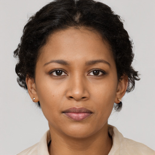 Joyful black young-adult female with short  brown hair and brown eyes