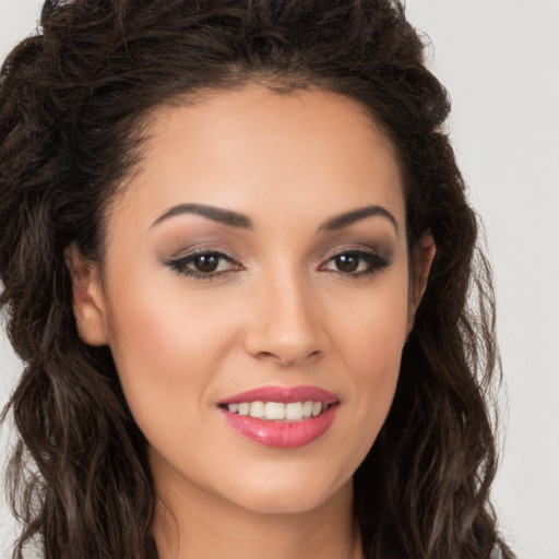 Joyful white young-adult female with long  brown hair and brown eyes