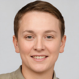 Joyful white young-adult female with short  brown hair and grey eyes