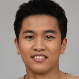 Joyful asian young-adult male with short  black hair and brown eyes