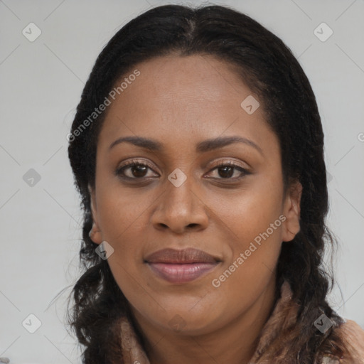 Joyful black young-adult female with long  brown hair and brown eyes