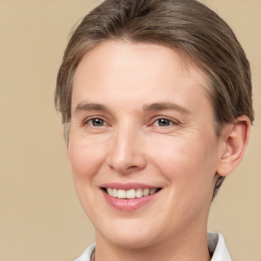 Joyful white young-adult female with short  brown hair and brown eyes