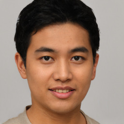 Joyful asian young-adult male with short  black hair and brown eyes