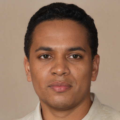 Joyful black young-adult male with short  black hair and brown eyes