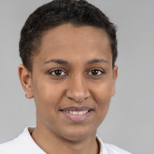 Joyful black young-adult female with short  brown hair and brown eyes