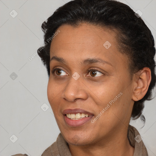 Joyful black adult female with short  brown hair and brown eyes