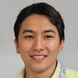 Joyful asian young-adult male with short  black hair and brown eyes