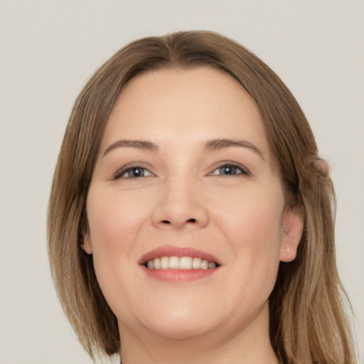 Joyful white young-adult female with long  brown hair and grey eyes