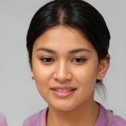 Joyful asian young-adult female with medium  brown hair and brown eyes