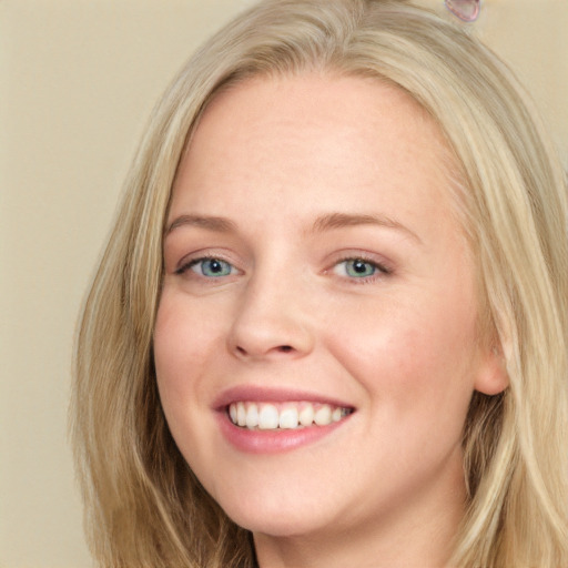 Joyful white young-adult female with long  brown hair and blue eyes