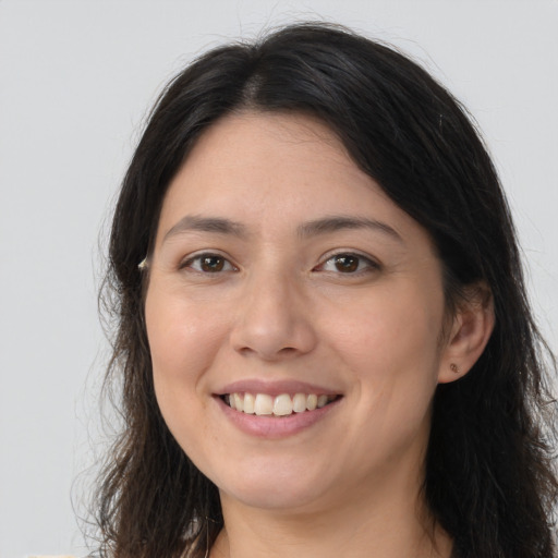 Joyful white young-adult female with long  brown hair and brown eyes