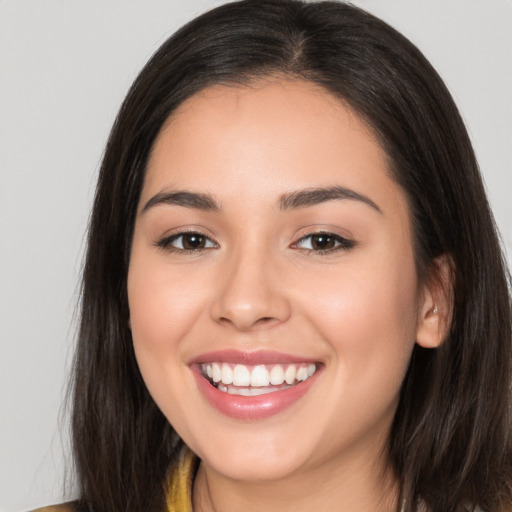 Joyful white young-adult female with long  brown hair and brown eyes