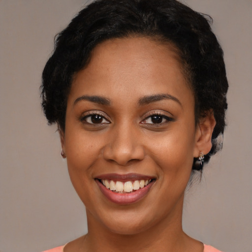 Joyful latino young-adult female with short  black hair and brown eyes