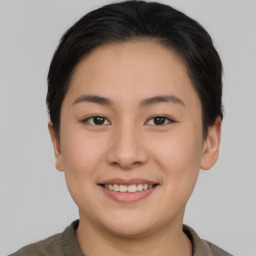 Joyful asian young-adult female with short  brown hair and brown eyes