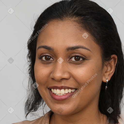 Joyful black young-adult female with long  brown hair and brown eyes