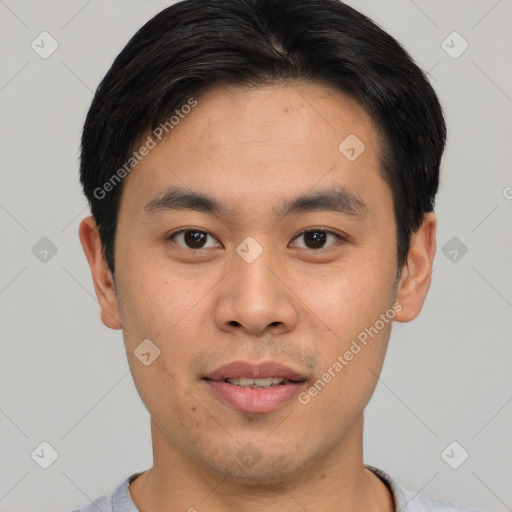 Joyful asian young-adult male with short  black hair and brown eyes