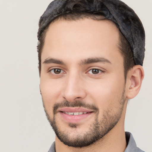 Joyful white young-adult male with short  black hair and brown eyes