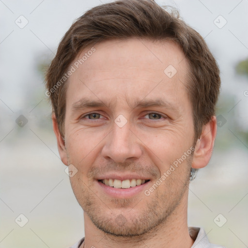 Joyful white adult male with short  brown hair and grey eyes