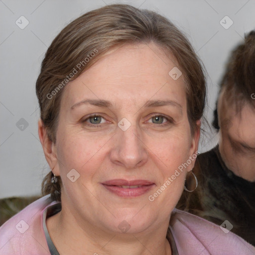 Joyful white adult female with medium  brown hair and blue eyes